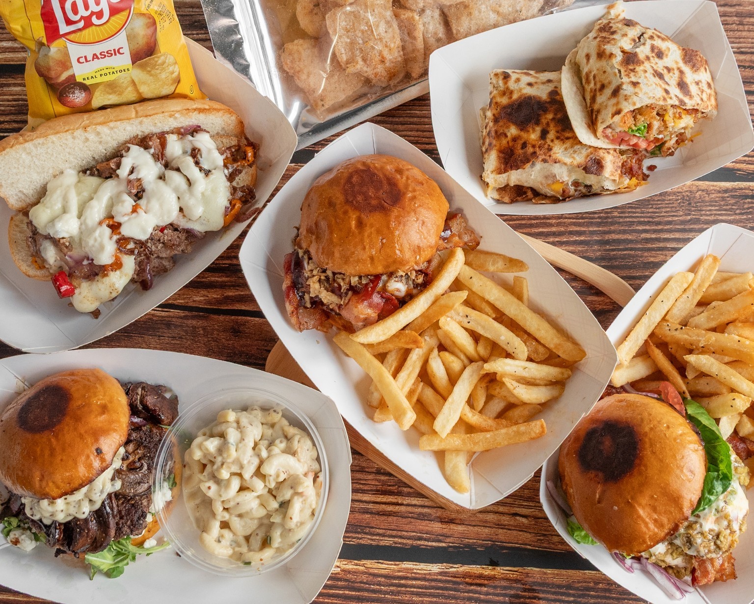 A spread of Jesse James Foods burgers, wraps, sandwiches, and sides